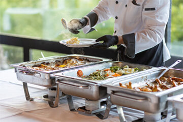 Event catering staff arranging buffet stations in Miami